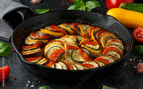 Ratatouille Vegetable Stew with zucchini, eggplants, tomatoes, garlic, onion and basil. on cast iron pan. Traditional French food. photo