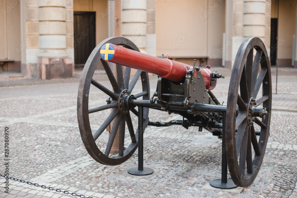 Swedish cannon gun fire in front royal Palace. Swedish flag colors: yellow and blue