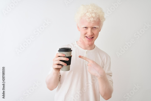 Young albino blond man drinking coffee standing over isolated white background very happy pointing with hand and finger