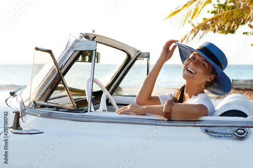 Photography Happy young woman and retro convertible car
