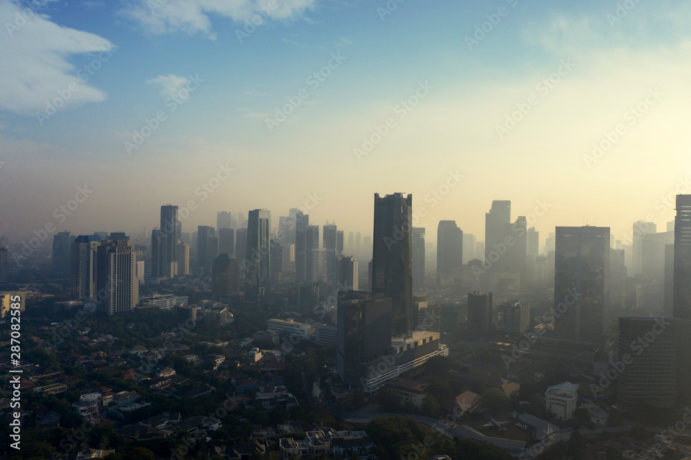 Plakat Jakarta city with air polluted at dawning time
