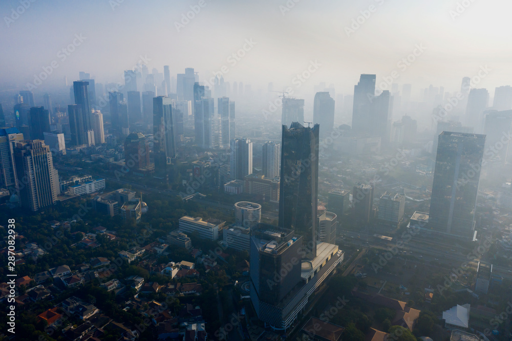 Jakarta cityscape with skyscraper and air pollution