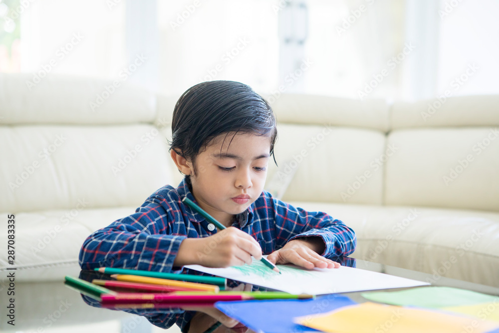 Little child drawing on a paper at home Little child drawing on a paper at home