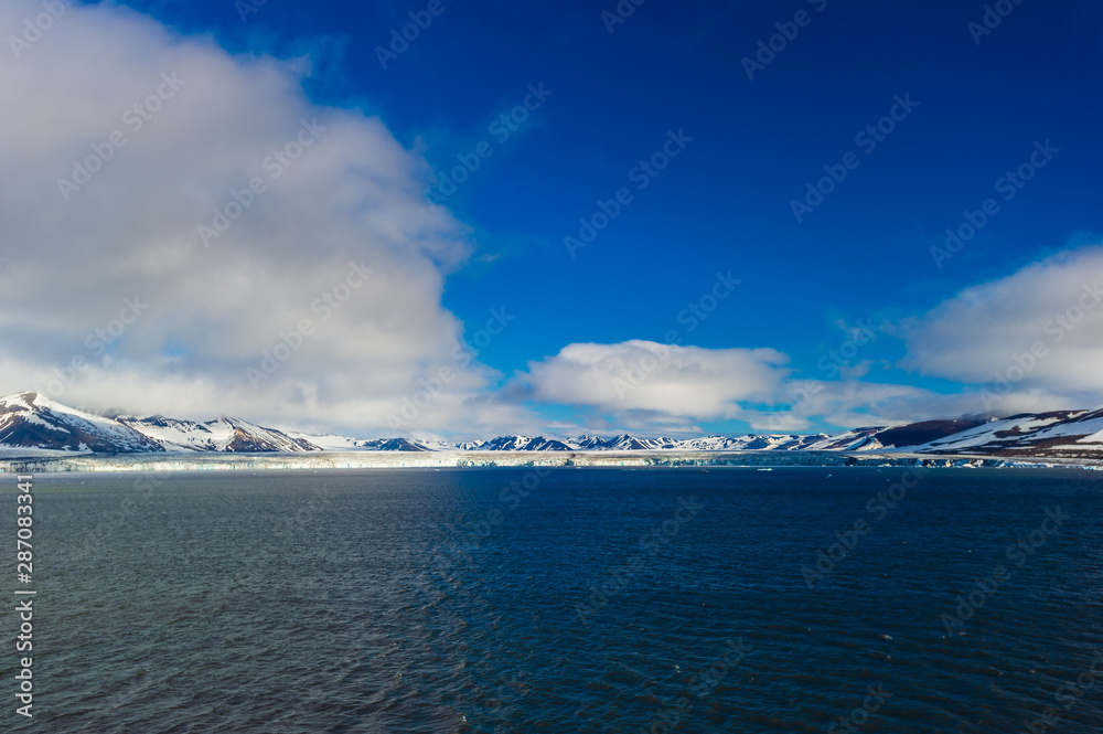 The end of a glacier in the Arctic Circle where it falls into the Arctic Ocean in Hornsund, Svalbard, Norway. The end of a glacier in the Arctic Circle where it falls into the Arctic Ocean in Hornsund, Svalbard, Norway.