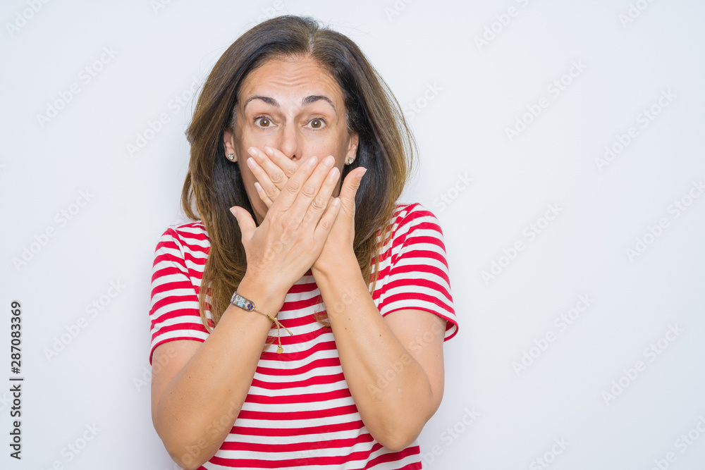 Middle age senior woman standing over white isolated background shocked covering mouth with hands for mistake. Secret concept. Middle age senior woman standing over white isolated background shocked covering mouth with hands for mistake. Secret concept.