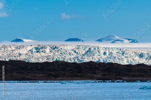 The end of a glacier in the Arctic Circle where it falls into the Arctic Ocean in Hornsund, Svalbard, Norway. photo