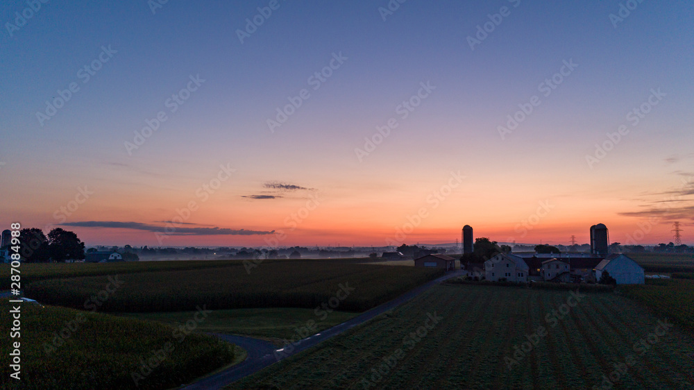 Sunrise Over an Amish Farm with Blues and Reds
