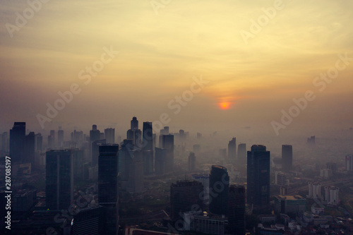 Skyscrapers and residential houses with foggy