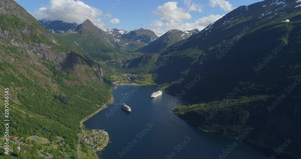 Aerial: Ships in Geirangerfjord amidst green mountain range on sunny day - Geiranger Fjord, Norway Aerial: Ships in Geirangerfjord amidst green mountain range on sunny day - Geiranger Fjord, Norway