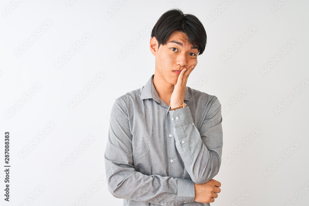 Chinese businessman wearing elegant shirt standing over isolated white background thinking looking tired and bored with depression problems with crossed arms. Chinese businessman wearing elegant shirt standing over isolated white background thinking looking tired and bored with depression problems with crossed arms.