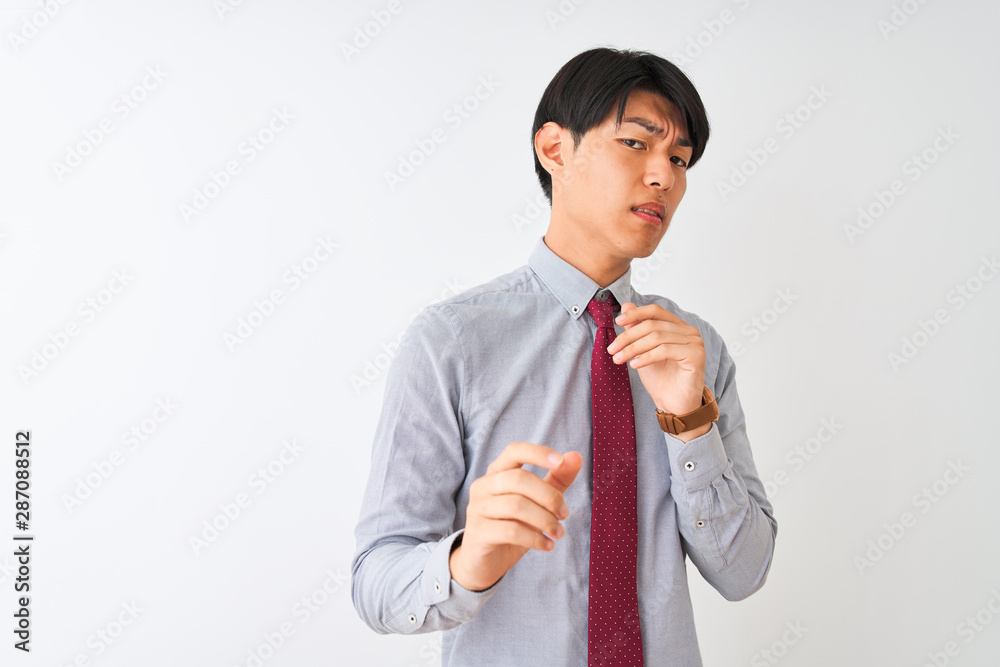 Chinese businessman wearing elegant tie standing over isolated white background disgusted expression, displeased and fearful doing disgust face because aversion reaction. With hands raised Chinese businessman wearing elegant tie standing over isolated white background disgusted expression, displeased and fearful doing disgust face because aversion reaction. With hands raised