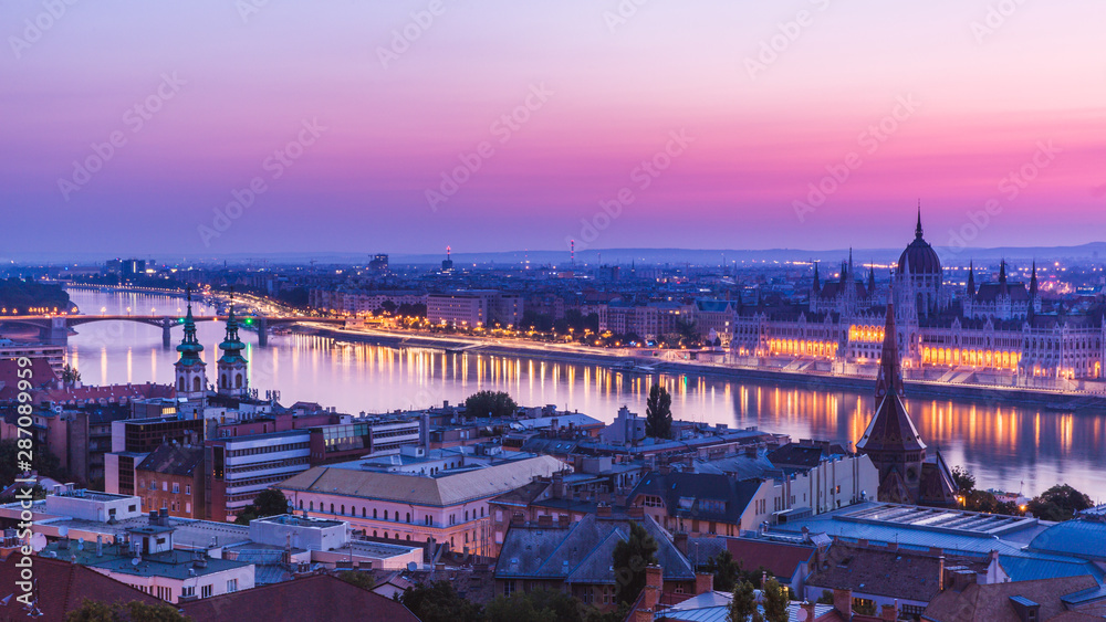 Panoramic cityscape of Hungarian parliament building with Margaret Bridge on the Danube river. Colorful sunrise in Budapest, Hungary