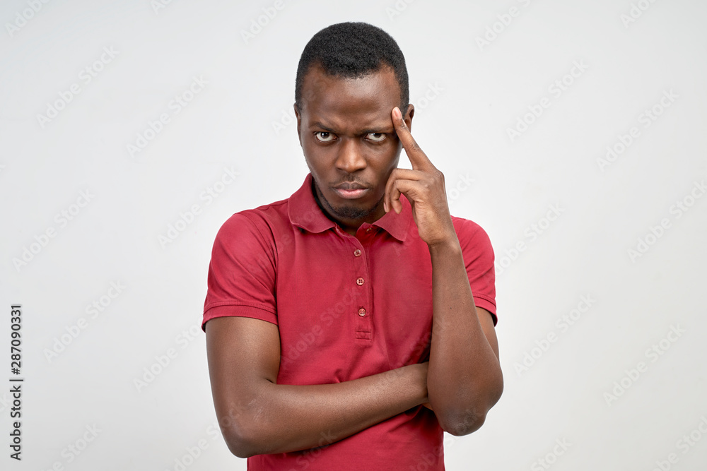 A man from under his forehead looks seriously A man from under his forehead looks seriously