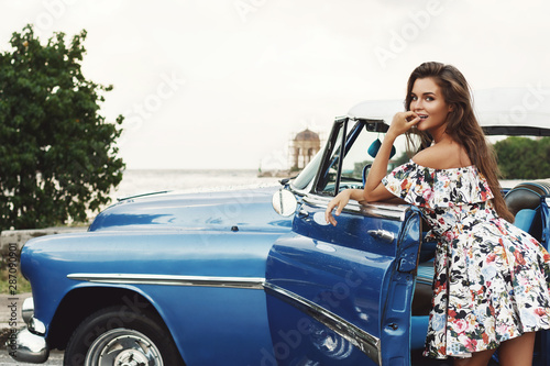 Beautiful woman driving a retro convertible car © blackday