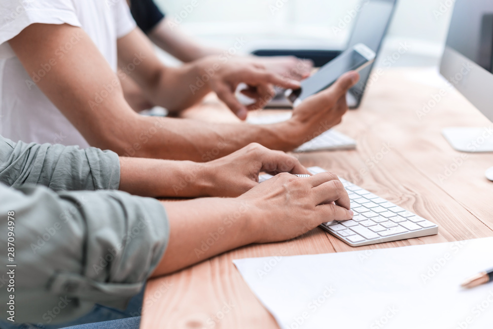 close up. a group of employees use devices in the office close up. a group of employees use devices in the office