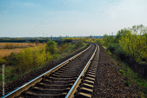 Empty railway track in sunny summer day