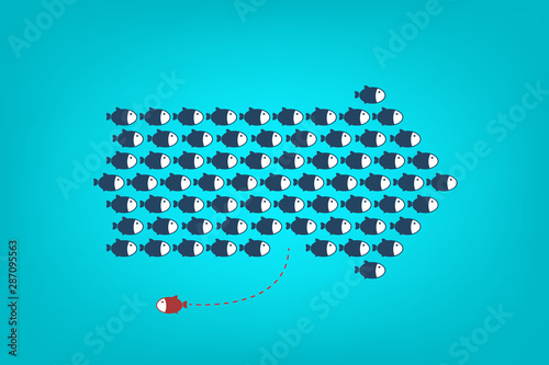 Think differently -One red unique different fish swimming opposite way of identical blue ones.	