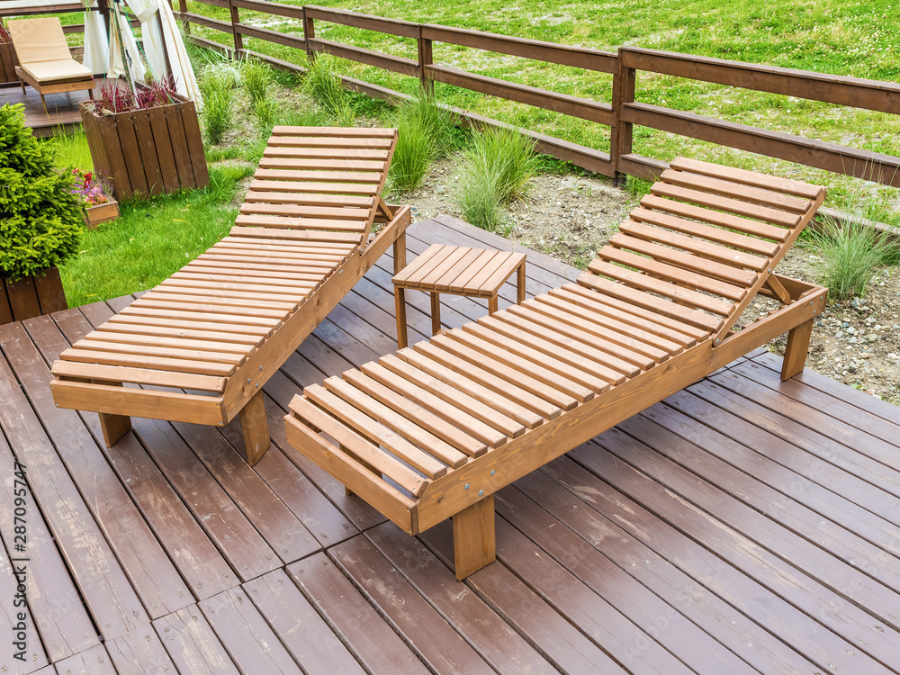 Wooden sunbeds for relaxing in the park at Rosa Khutor