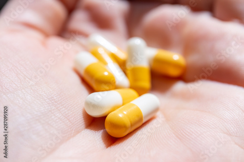 Close up hand of woman overdosing on medication. Close up of overdose pills in addict hand. Overdose concept. photo