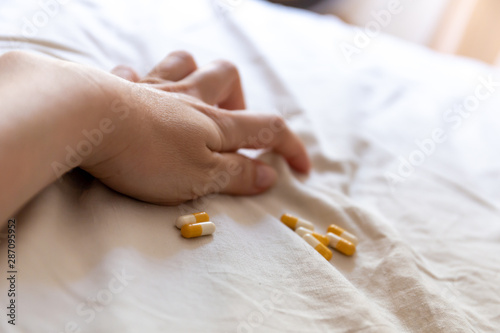 Close up hand of woman overdosing on medication. Close up of overdose pills in addict hand. Overdose concept. photo