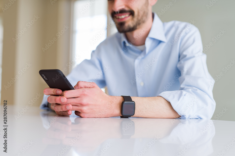 Close up of business man working using smartphone smiling confident Close up of business man working using smartphone smiling confident