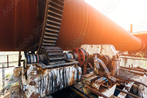 Old rusty rotating kiln in cement manufacturing plant