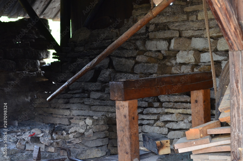 The interior of an old forge in a medieval castle, a furnace and old brick walls. The interior of an old forge in a medieval castle, a furnace and old brick walls.