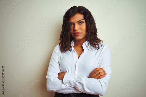 Beautiful transsexual transgender elegant businesswoman over isolated white background skeptic and nervous, disapproving expression on face with crossed arms. Negative person.