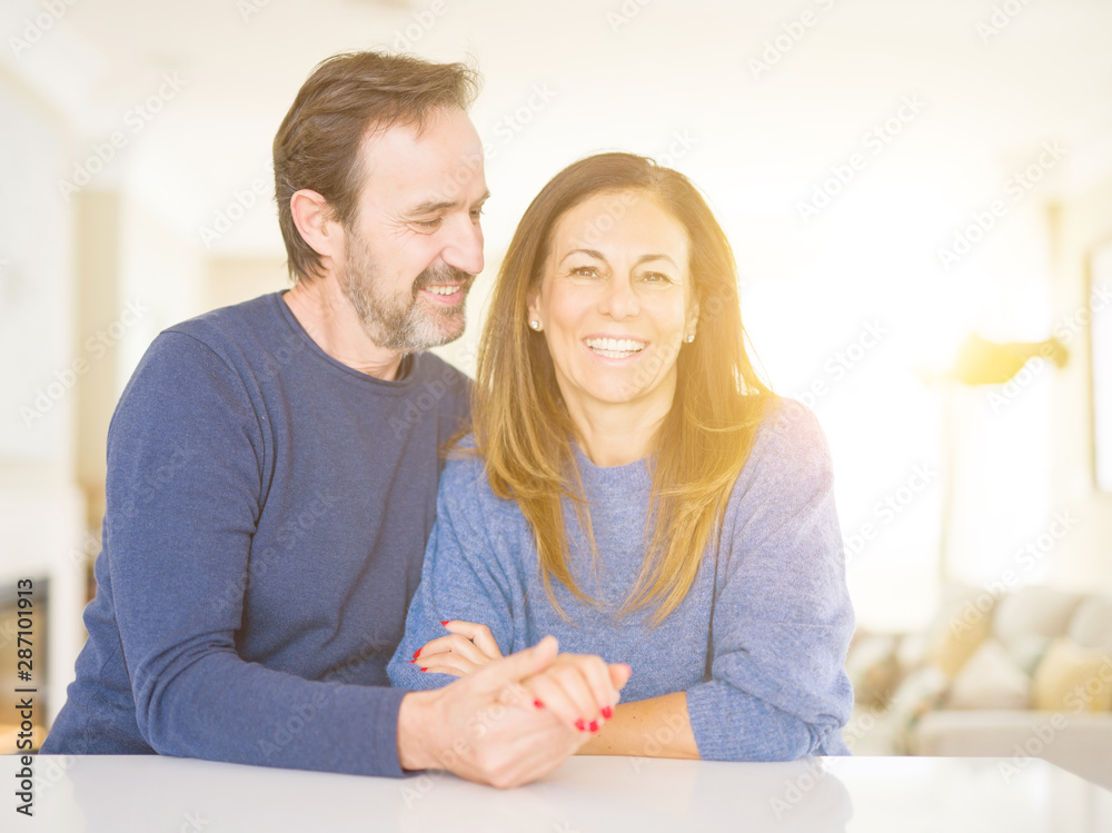 Romantic middle age couple sitting together at home