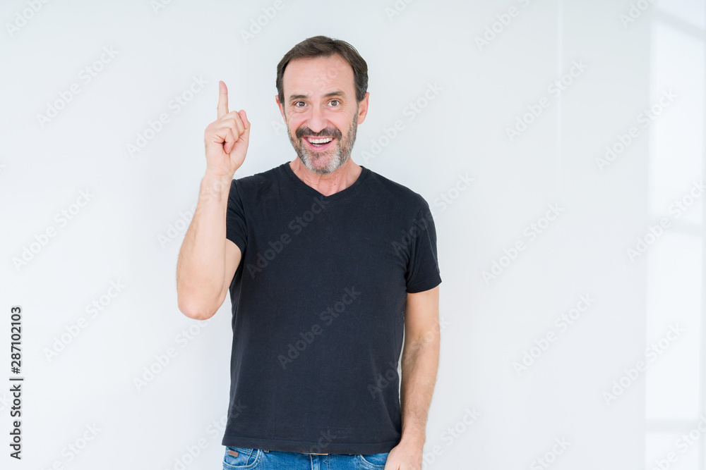 Fototapeta premium Senior man over isolated background pointing finger up with successful idea. Exited and happy. Number one.