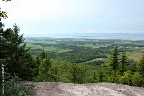 Mountain view of river, island and town. Pain de sucre mountain, Cap-St-Ignace, Qc. Canada. during summer