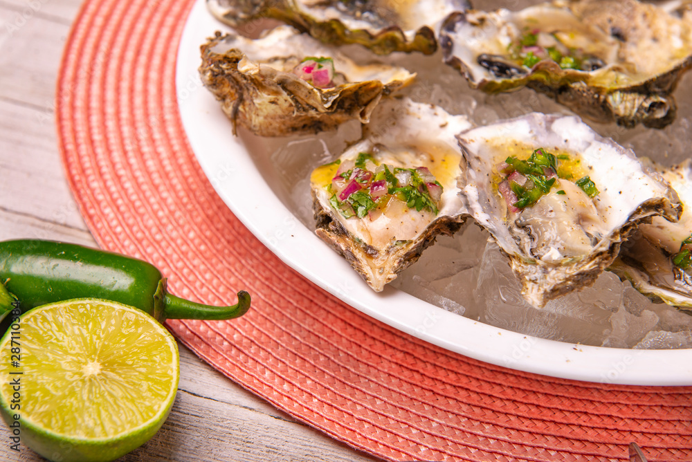 Fresh shucked oysters with jalapeno & lemon mignonette