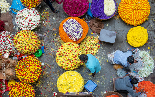 People selling Fresh flowers in wholesale inside KR flower market India which is one of the biggest flower markets in Asia