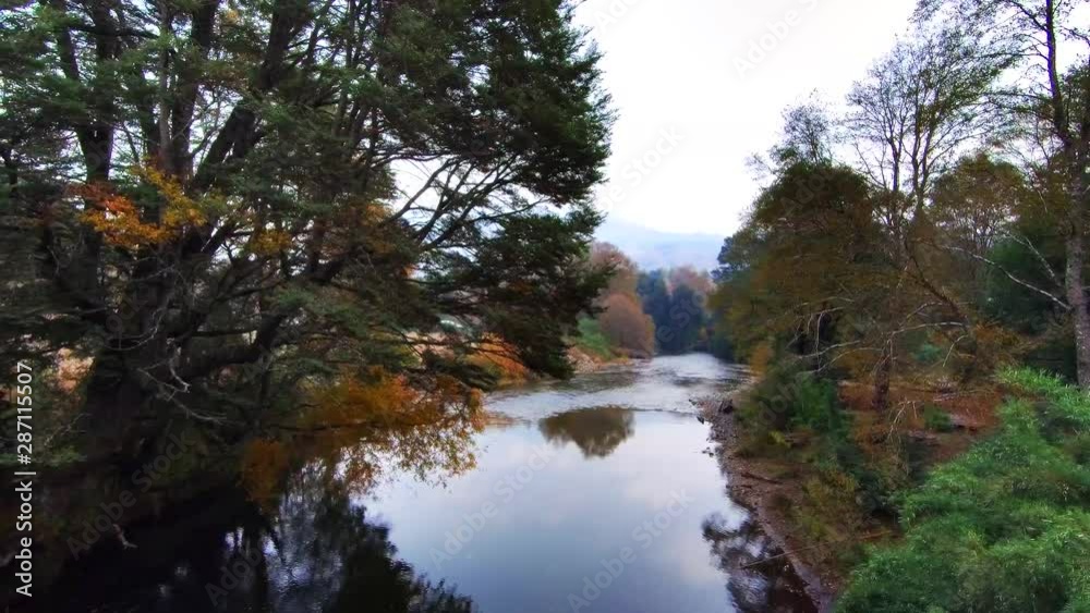 silent river with trees in autumn colors silent river with trees in autumn colors