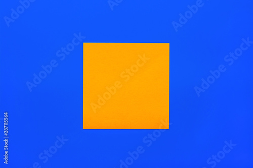 Reminder and combination concept- Close up one yellow empty square sticker on blue background with copy spase, mock up horizontal orientation