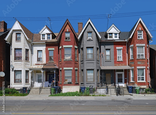 Photography row of old Victorian urban houses with gables