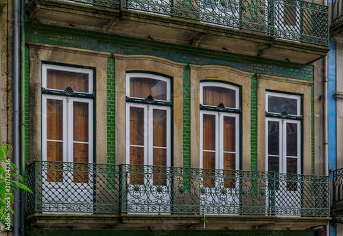 Facades of traditional houses decorated with ornate Portuguese azulejo tiles in Porto, Portugal