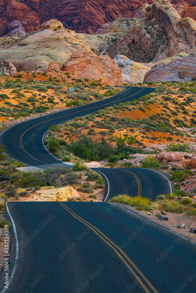 Travel down a winding desert road toward adventure