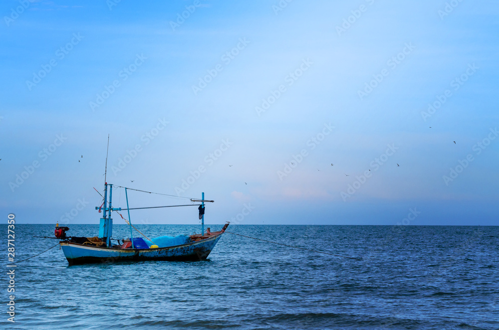 The Old fishing Boat on the sea with lighting