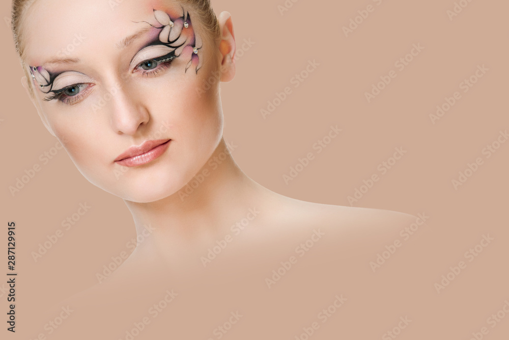 Beautiful face of a woman with Creative makeup - on background salmon shade red