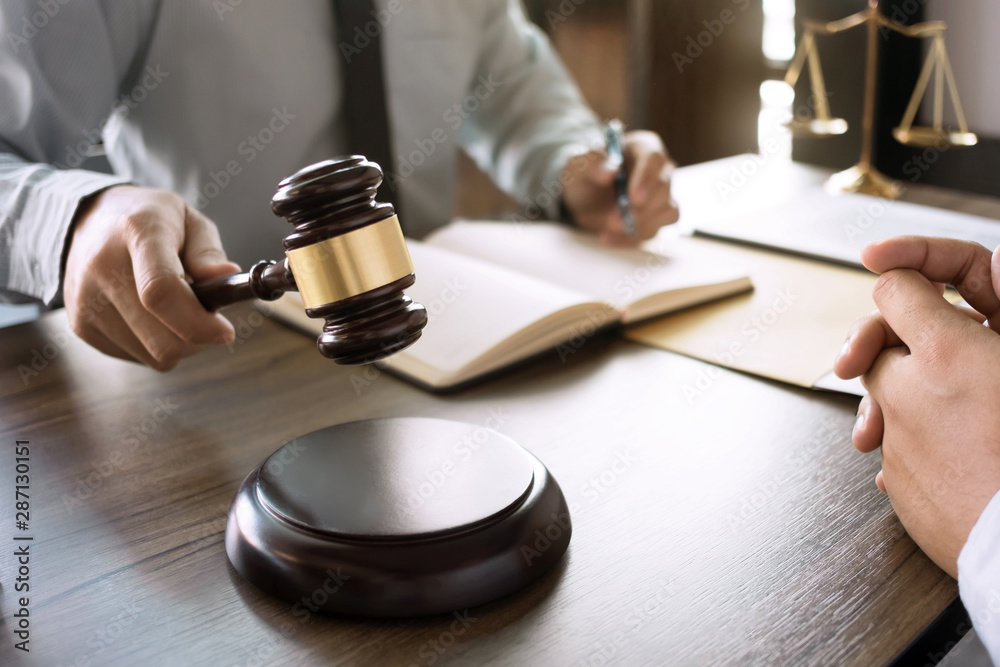 Justice lawyer consulting give a advice with client in courtroom. Justice lawyer consulting give a advice with client in courtroom.