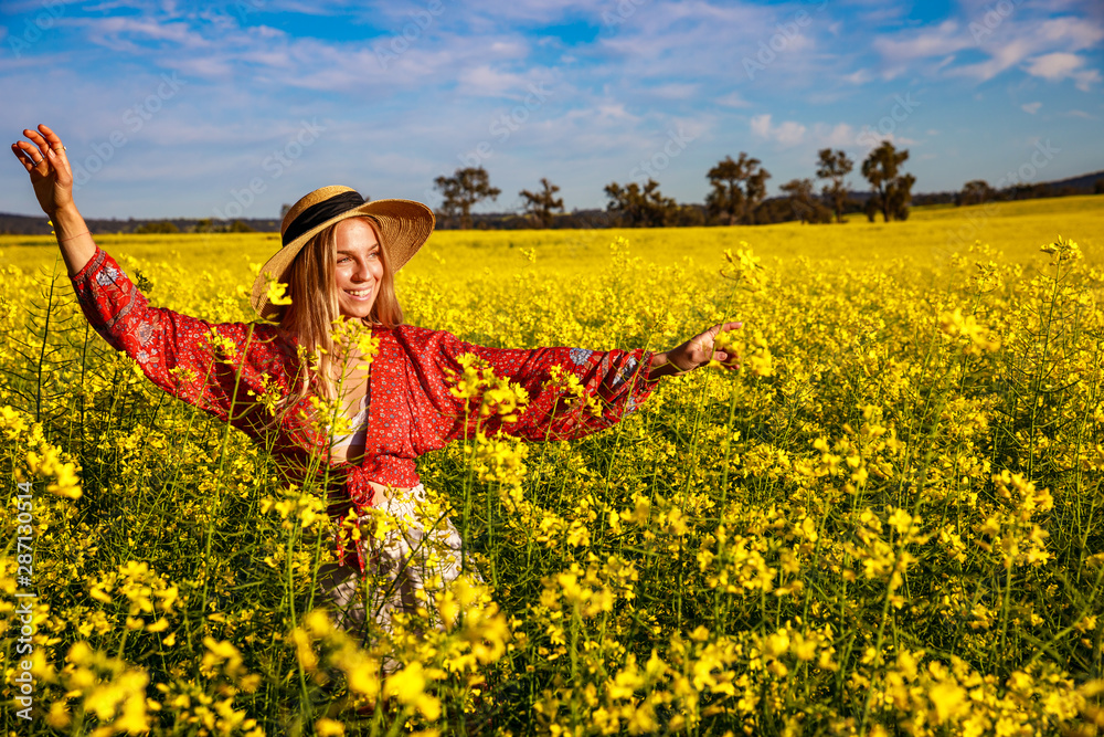 Smiling Young Woman in Flowering Canola Field in Western Australia Smiling Young Woman in Flowering Canola Field in Western Australia