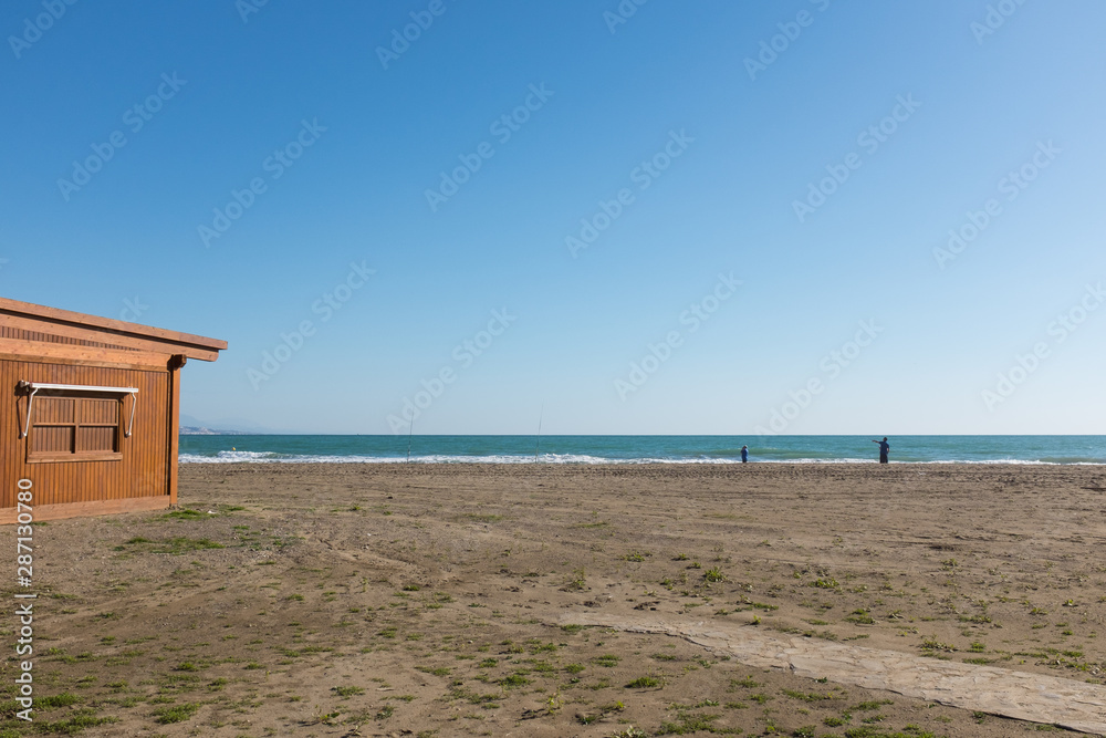 landscape of a malaga beach with people silhouette