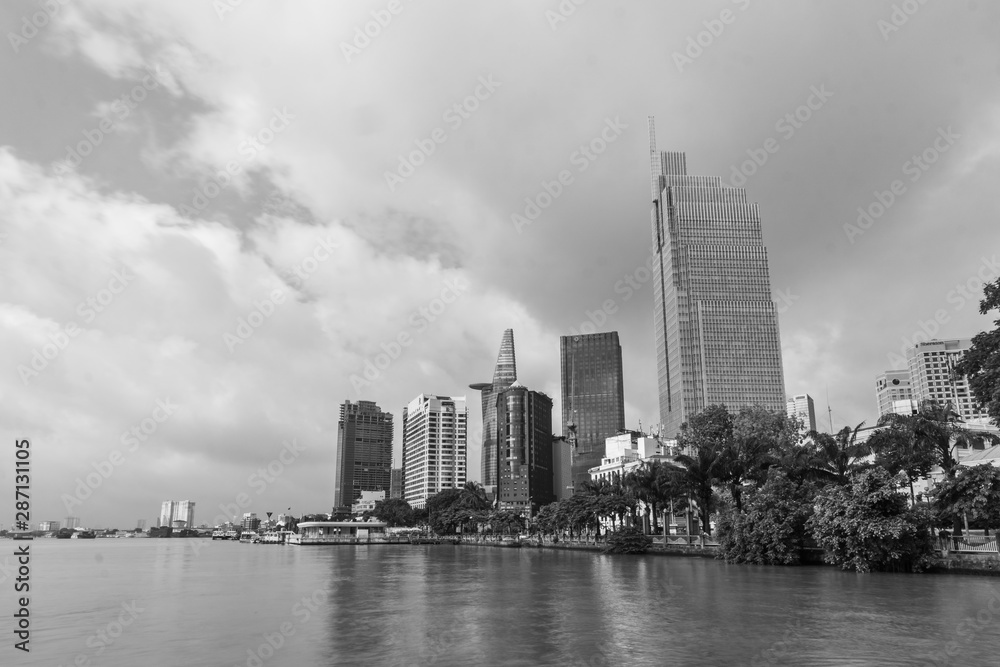 black and white skyline view from the river. modern building, high rise Relection on water of  Asiatic Metropolis of  Saigon know also as Ho Chi Minh city, Vietnam.