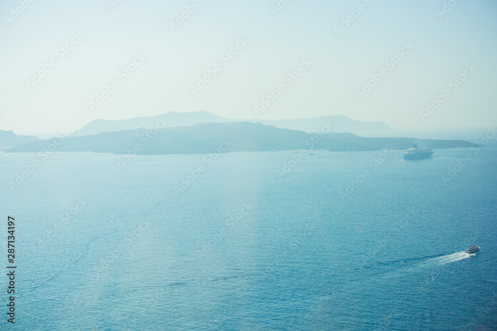 Picturesque view of view on a Santorini island and mountains. Vacations time Picturesque view of view on a Santorini island and mountains. Vacations time