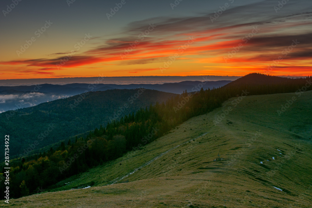 A beautiful autumn dawn in the Ukrainian Carpathian Mountains, with fogs in the valleys and forests, and yellow-red trees. A beautiful autumn dawn in the Ukrainian Carpathian Mountains, with fogs in the valleys and forests, and yellow-red trees.