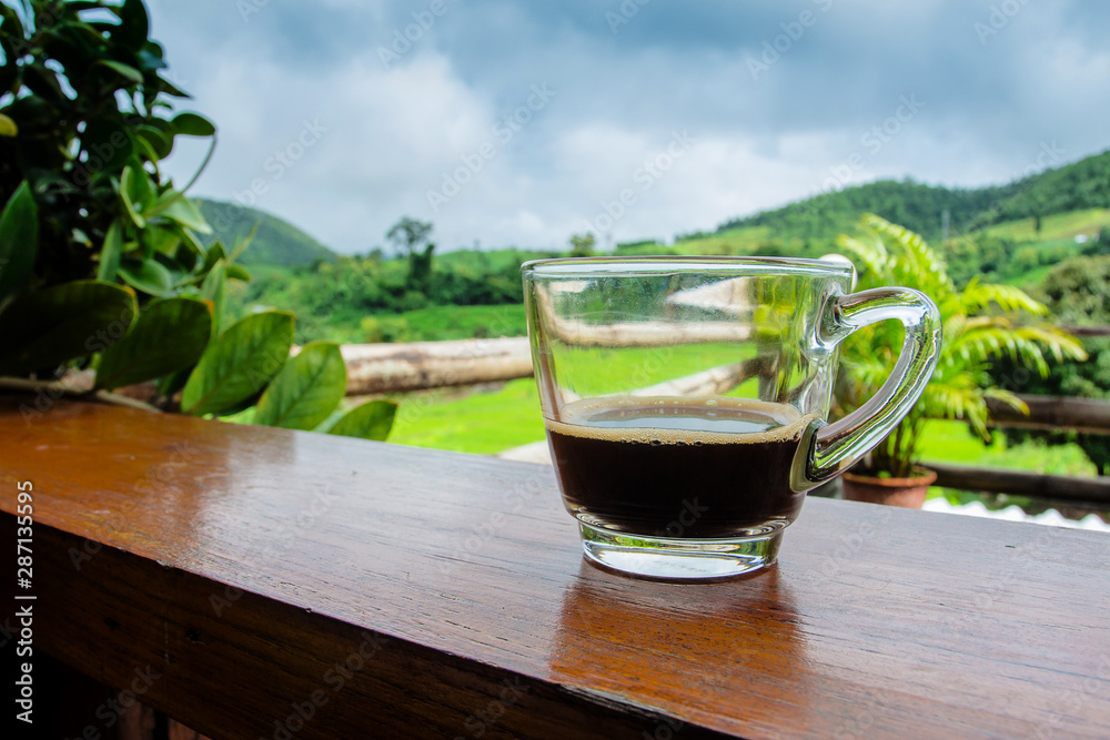 Cup of black coffee on a wooden table with copy space - vintage effect style. Cup of black coffee on a wooden table with copy space - vintage effect style.