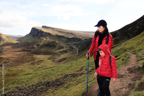 Happy family exploring and hiking scenic mountains