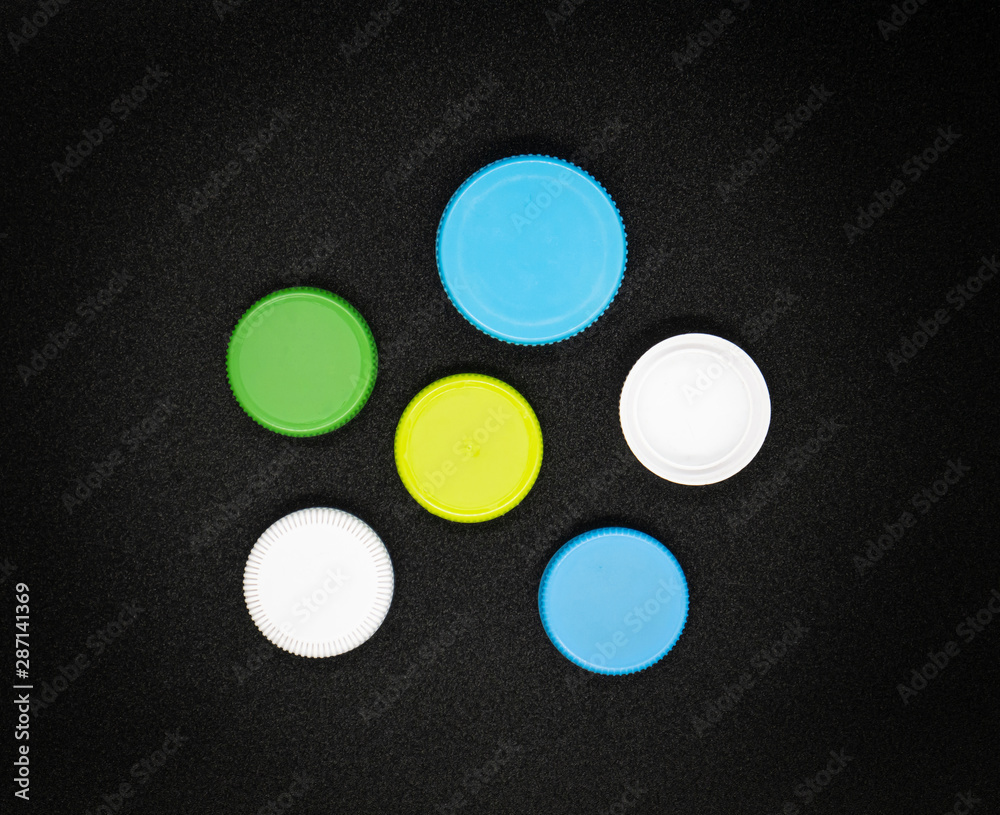 Colorful Plastic bottle caps on black background.