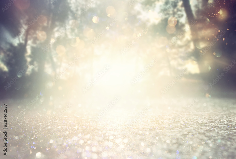 Abstract background of light burst among trees and glitter golden bokeh lights Abstract background of light burst among trees and glitter golden bokeh lights